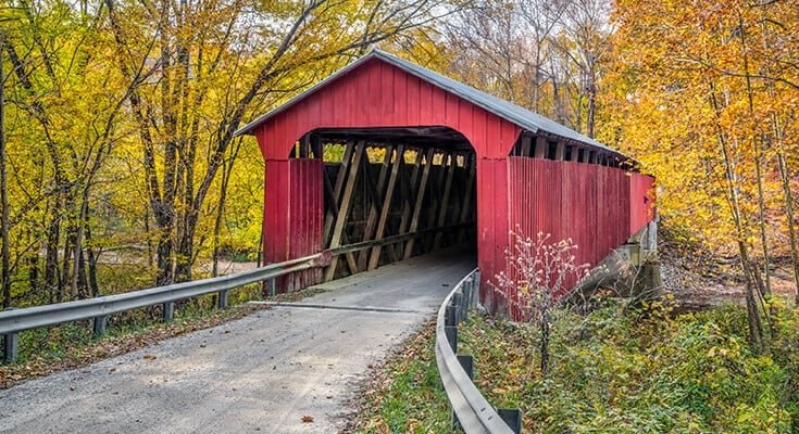 Autumn photography - Red covered bridge and autumn leaves.