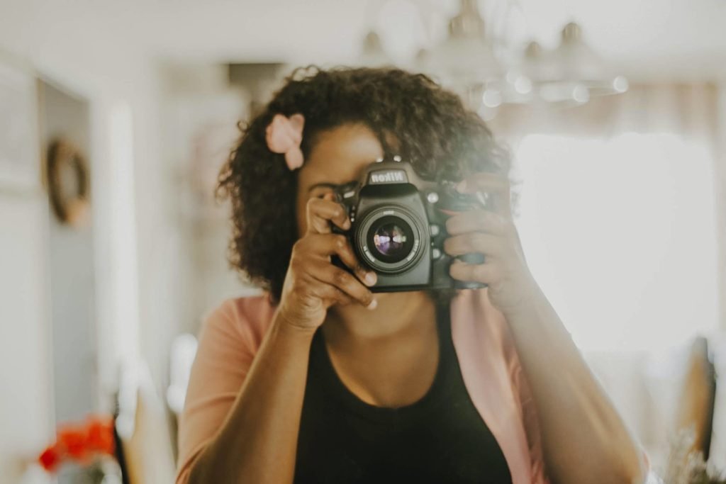mirror selfie of woman getting started in photography.