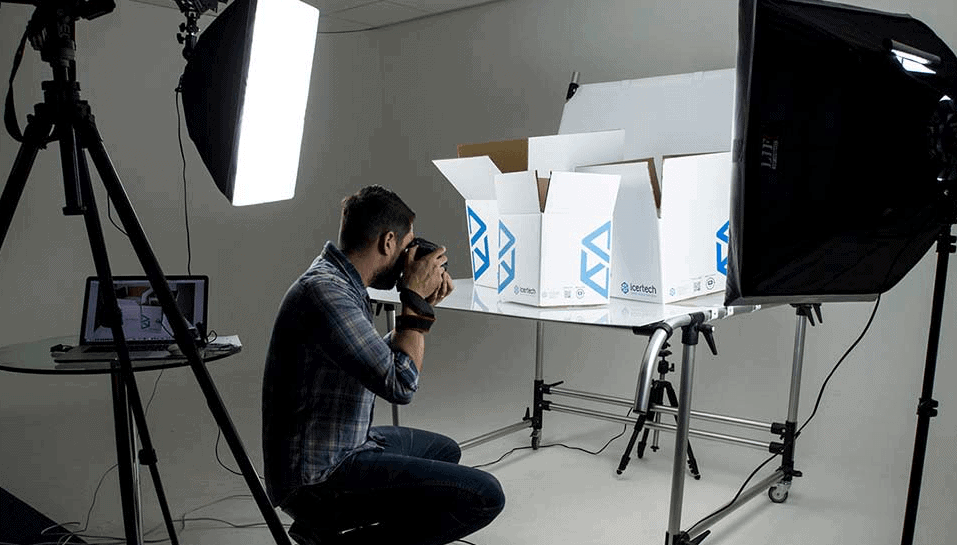 photographer taking pictures of  products in a studio.