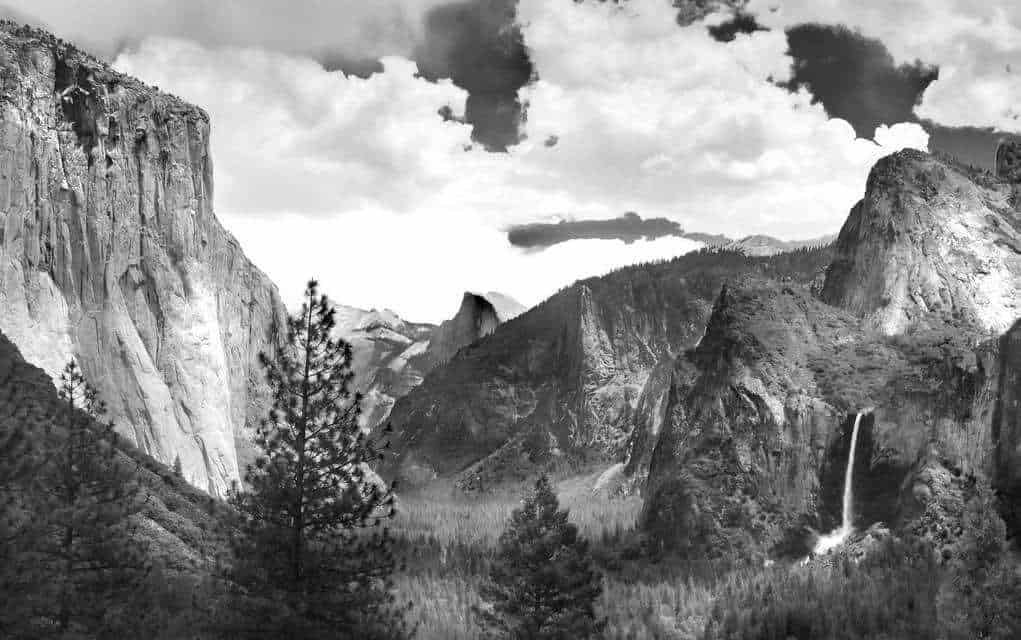 A black and white photograph of mountains photographed by Ansel Adams.