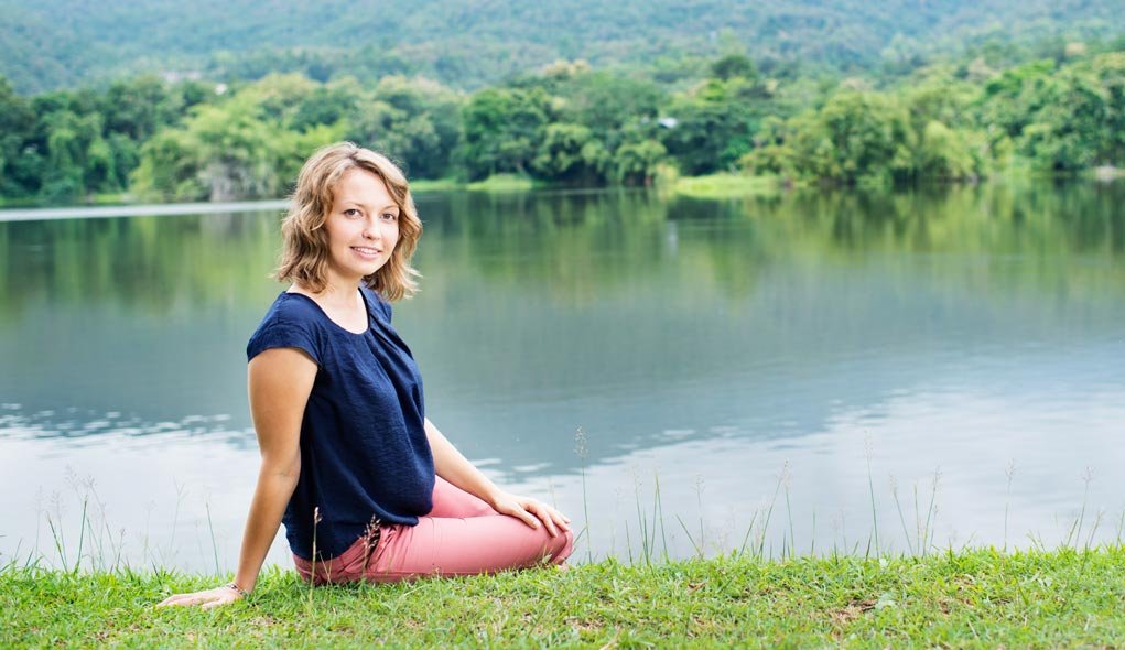 portrait of a woman beside a lake using the rule of thirds.