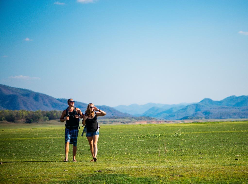 couple walking in the field.