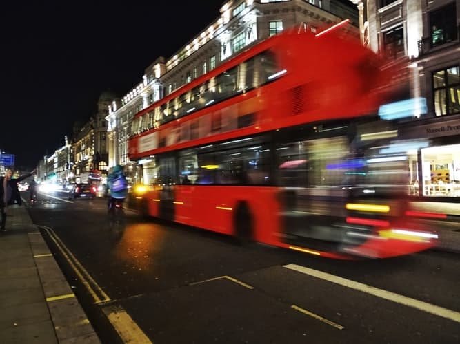 Camera settings for low light can prevent motion blur, but sometimes you might want that to create a more abstract photo, like this one of a double deck bus moving down the road.