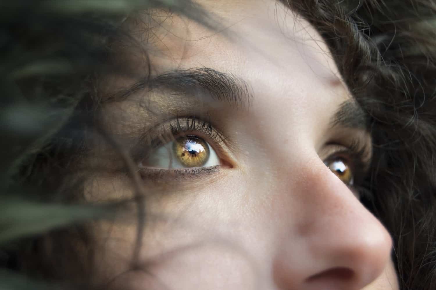 Close-up portraits should always focus on the eyes, as seen in this close-up of a woman's eyes.