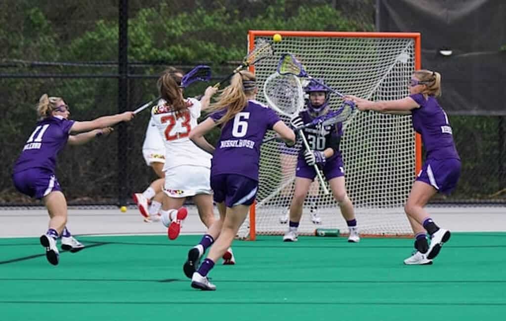 A telephoto zoom lens can help sports photographers get in close to the action, as seen in this image of lacrosse players. 
