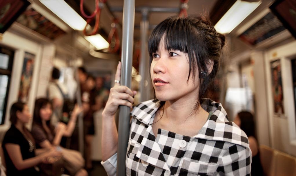 photo of a woman on a train, captured with bounce flash.