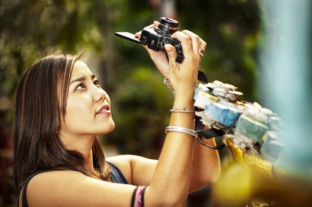 woman taking a photo for choosing a camera.