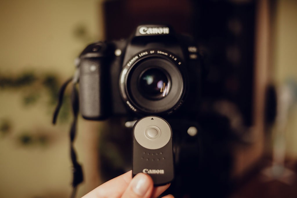 camera remote pointing at a DSLR camera.