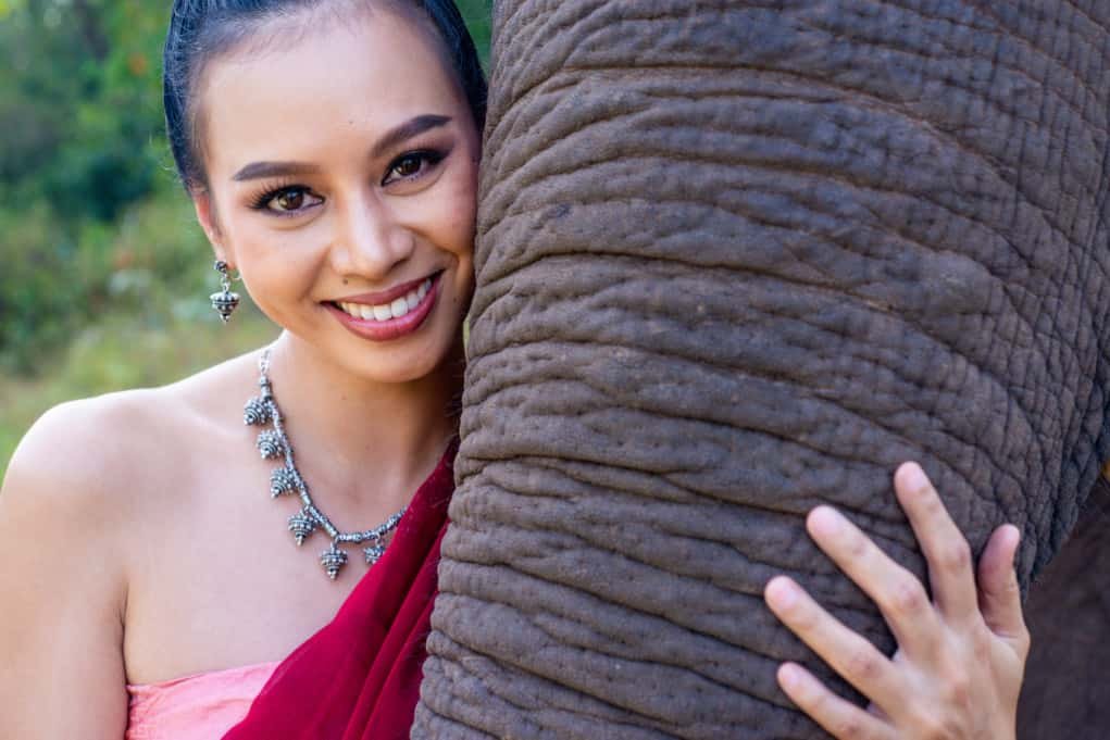 Thai woman close up with elephant trunk for shooting in manual mode.