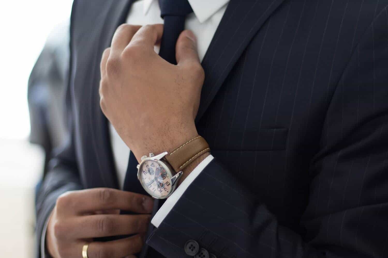 It's important with fashion photography shots to get the details, like this shot of a man's hand while he straightens his tie.