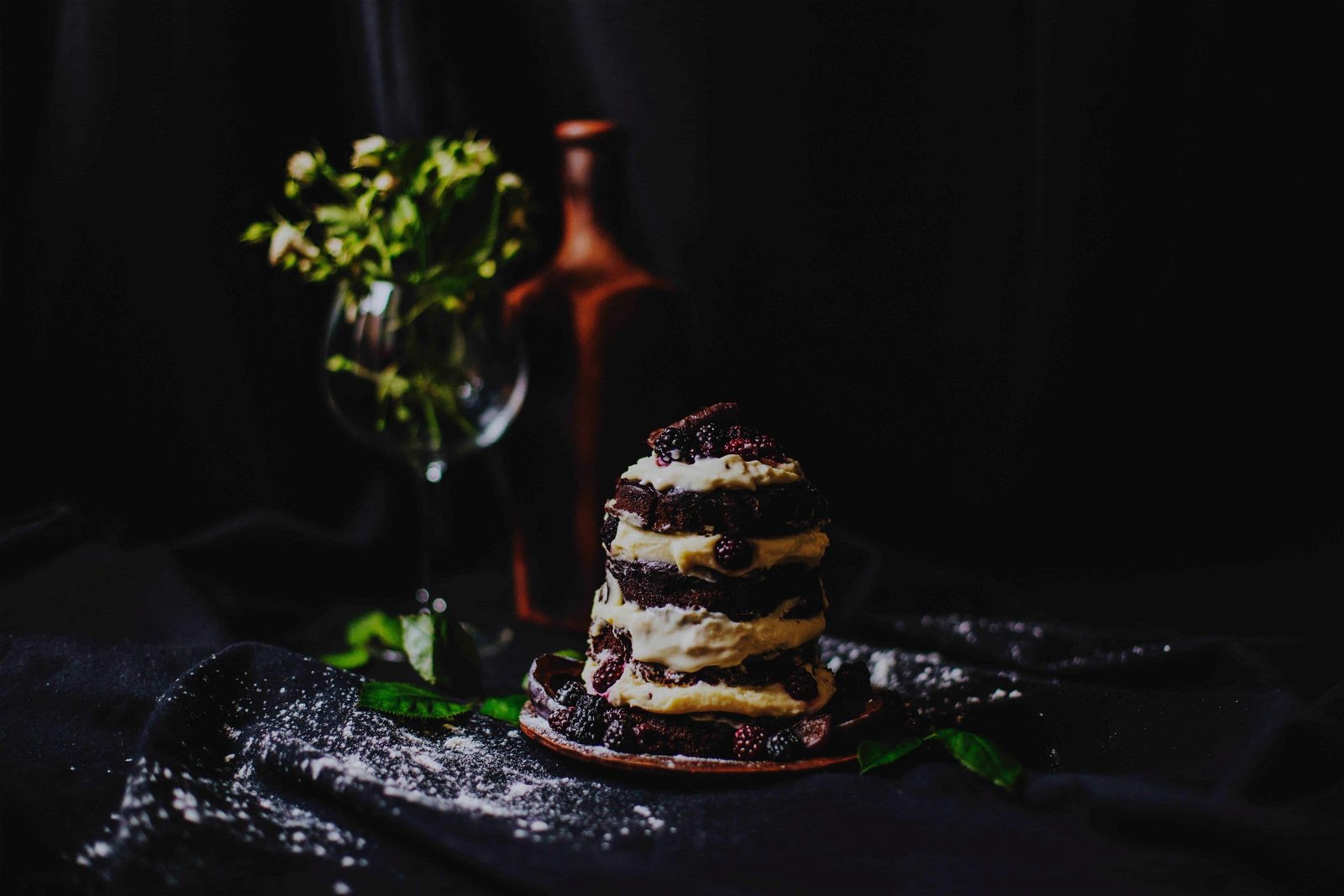 Using a dark board in food photography setup can create more contrast and shadows as seen in this image of dessert