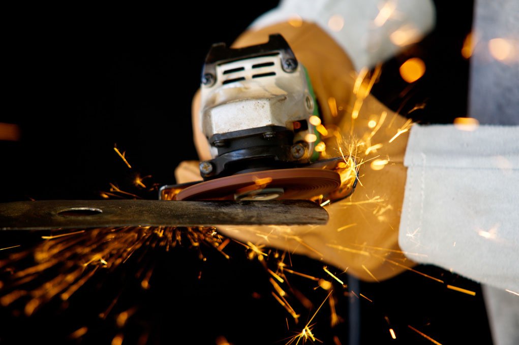 close up of an angle grinder and sparks with a shallow depth of field.