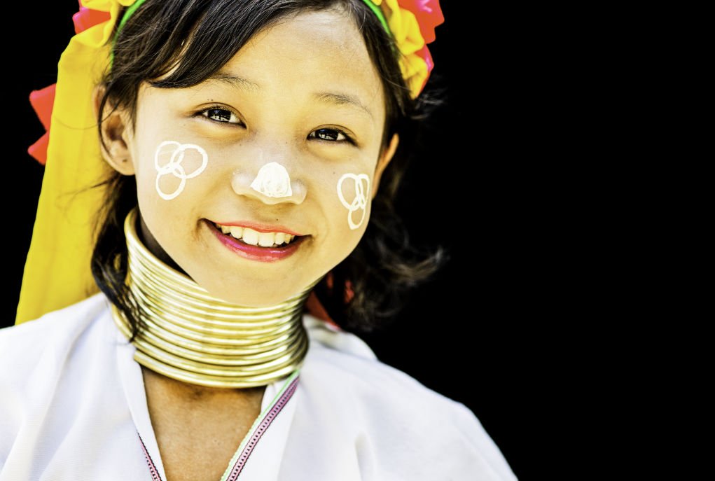 young Kayan girl isolated on a dark background.