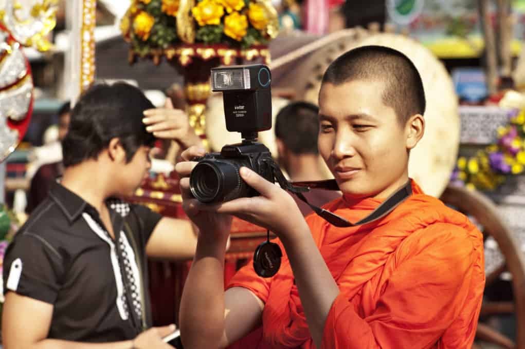 Buddhist monk taking a photo.
