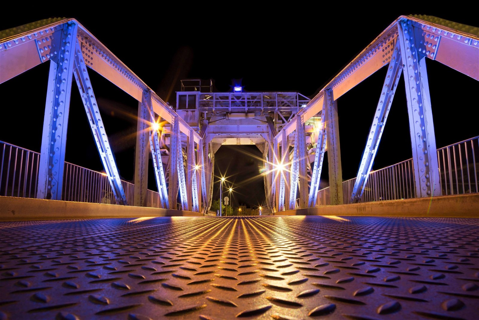 Stay out late is a travel photography tip that can help you capture unique images with no one in them, like this bridge late at night.