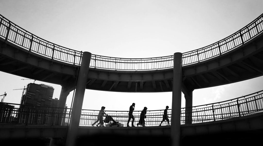 high contrast exposure of people walking in an overpass