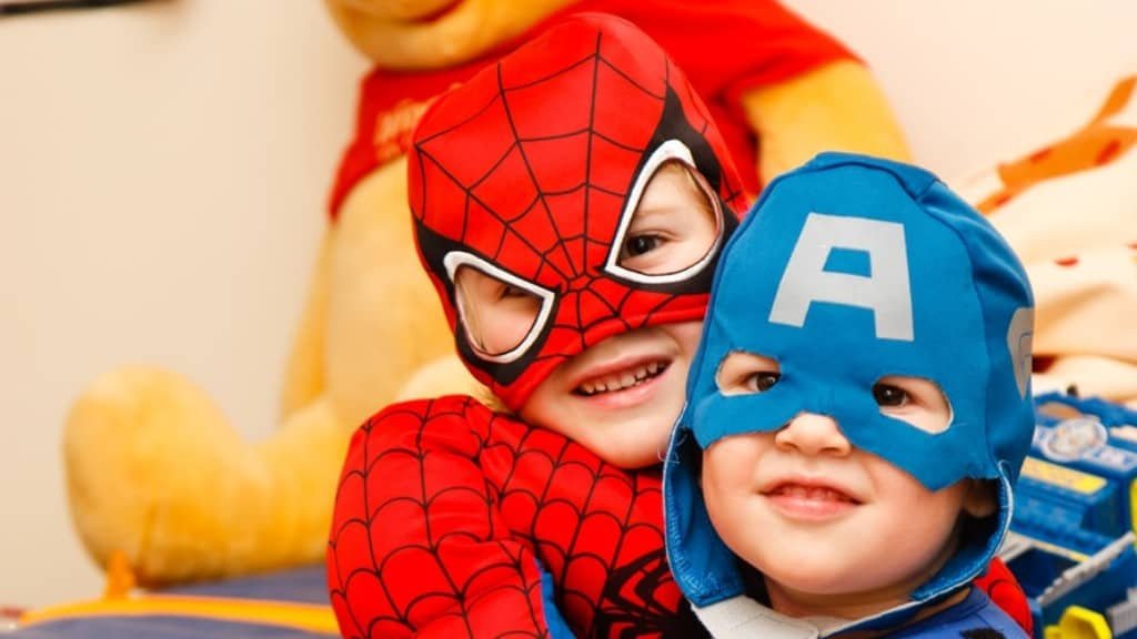 Image of children in superhero costumes.