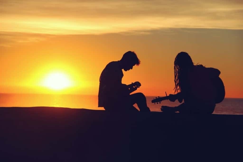 Couple playing the guitar.