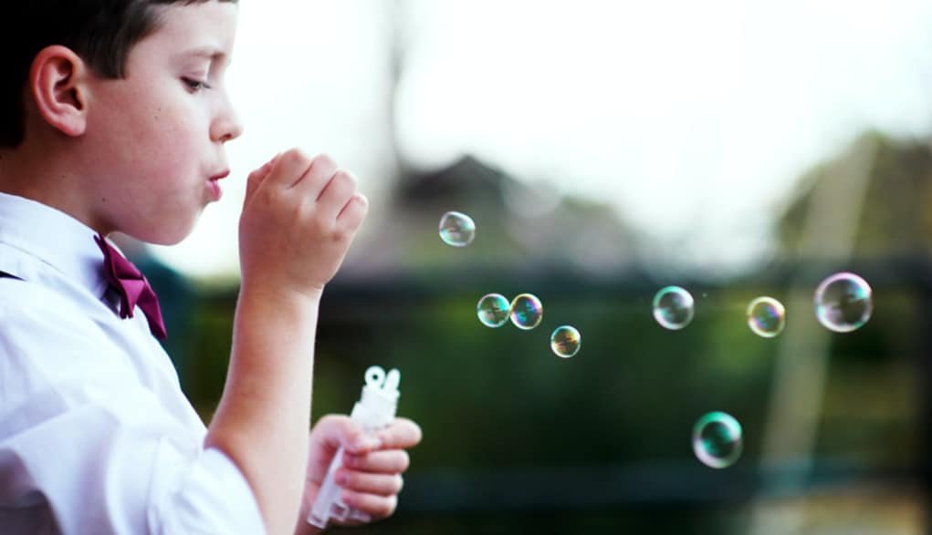 boy blowing bubbles.