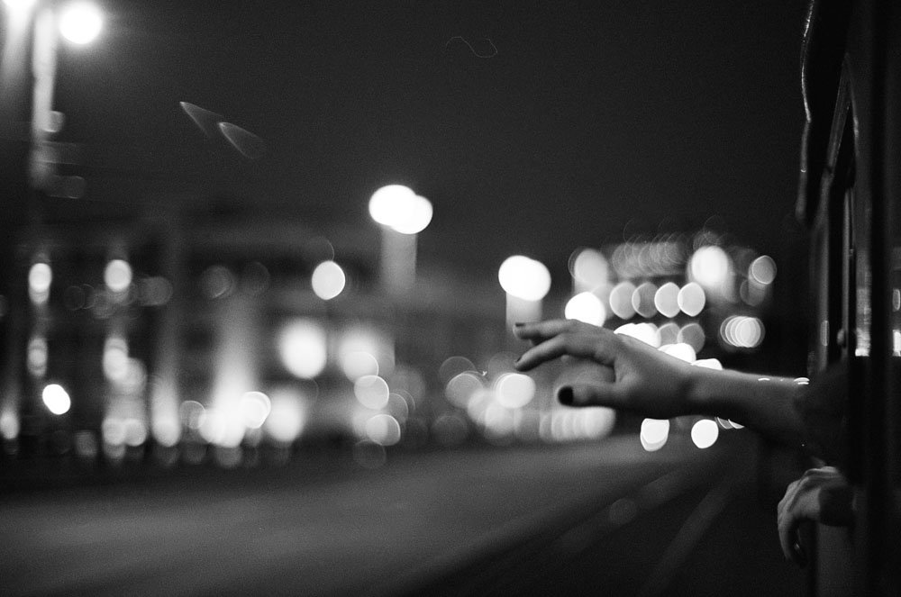 Black and white image of city lights in the dark.