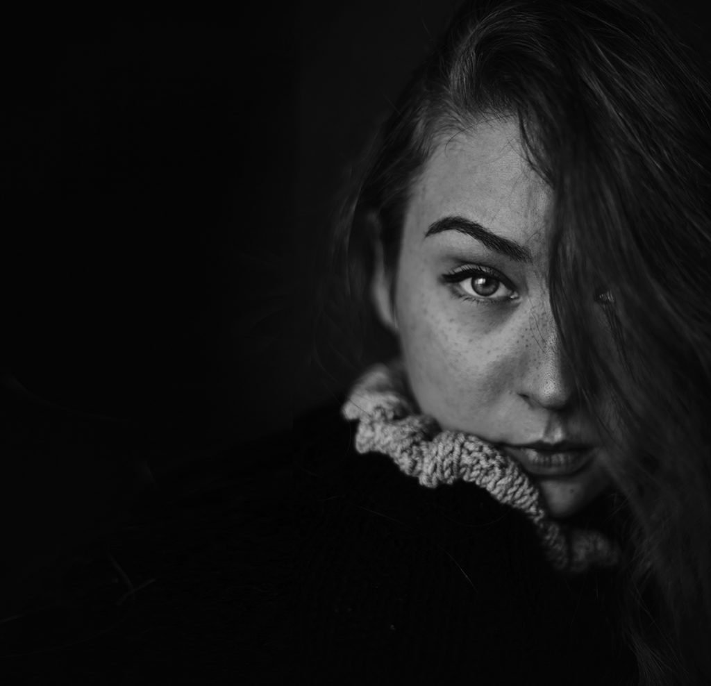 Mysterious black & white self-portrait featuring a freckled girl.