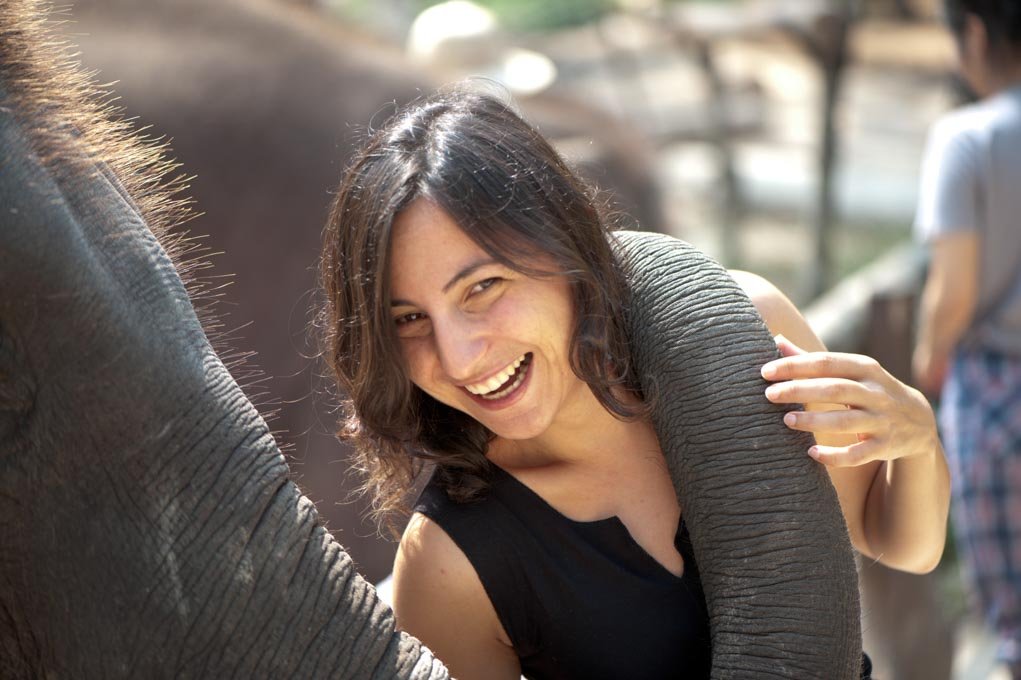 close up portrait of woman with an elephant.