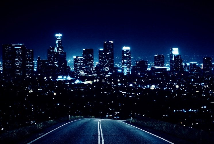 glowing night city with dark road.