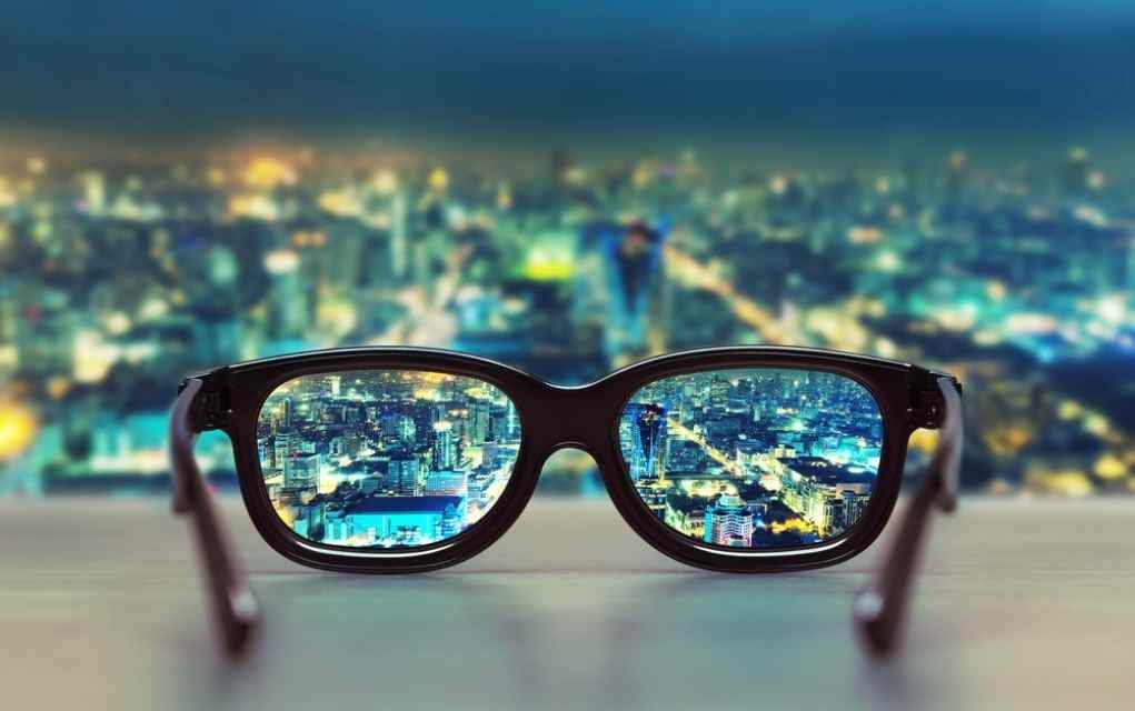 city reflecting in glasses.