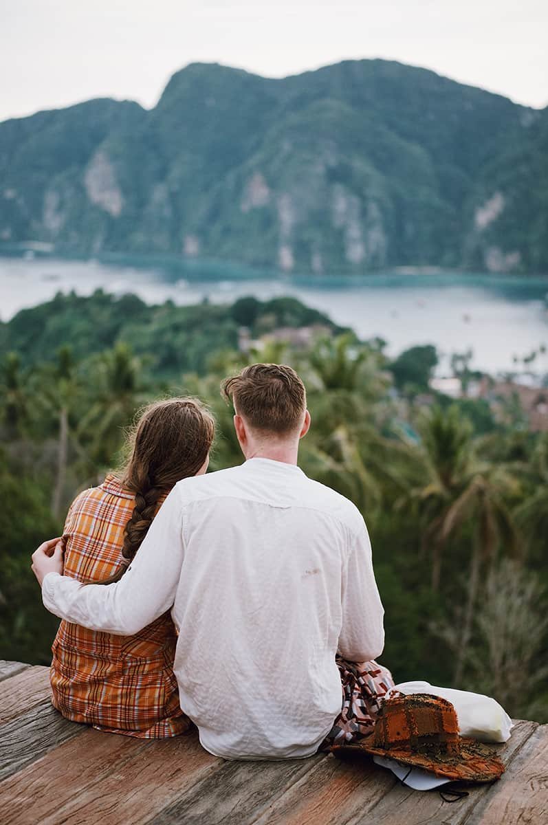 couple poses enjoying a view together