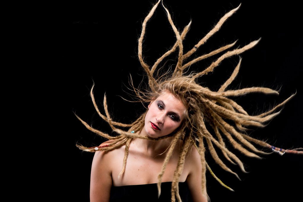 studio portrait of woman with dreadlocks for how to unblur an image.