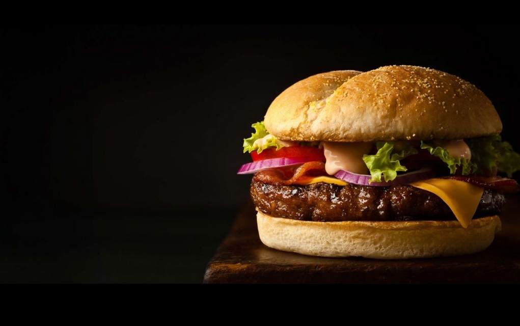 delicious beef burger with a dark background.