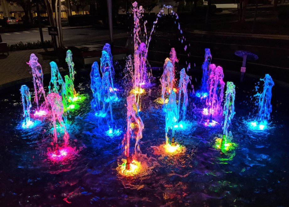 fountain with lights at night.