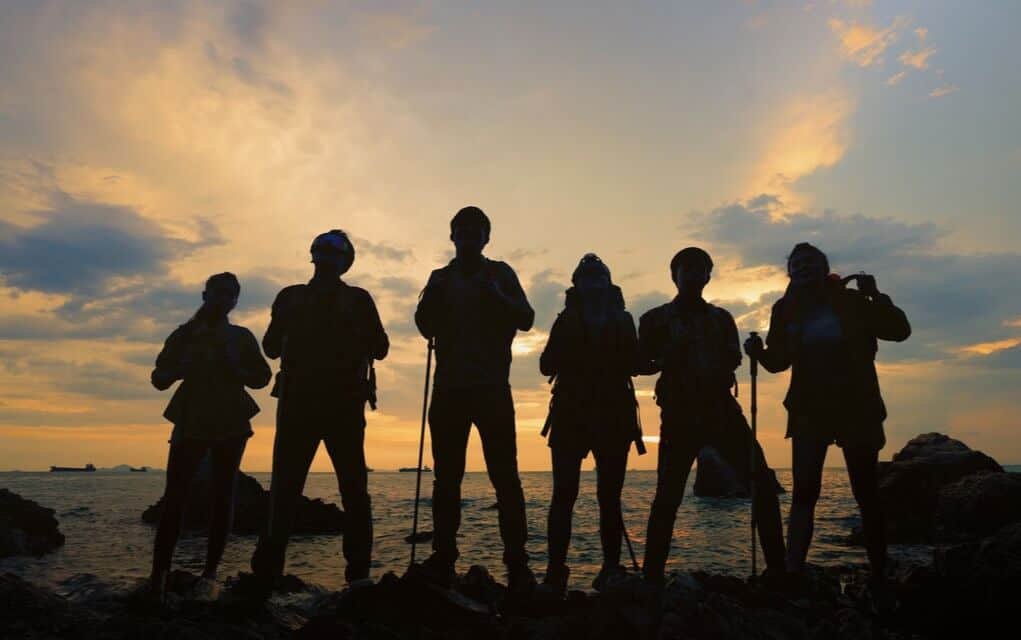 group of people silhouetted against the sunset
