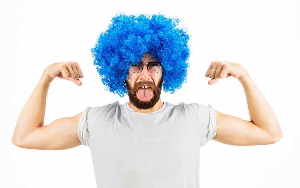 High key portrait of a man with a blue wig.