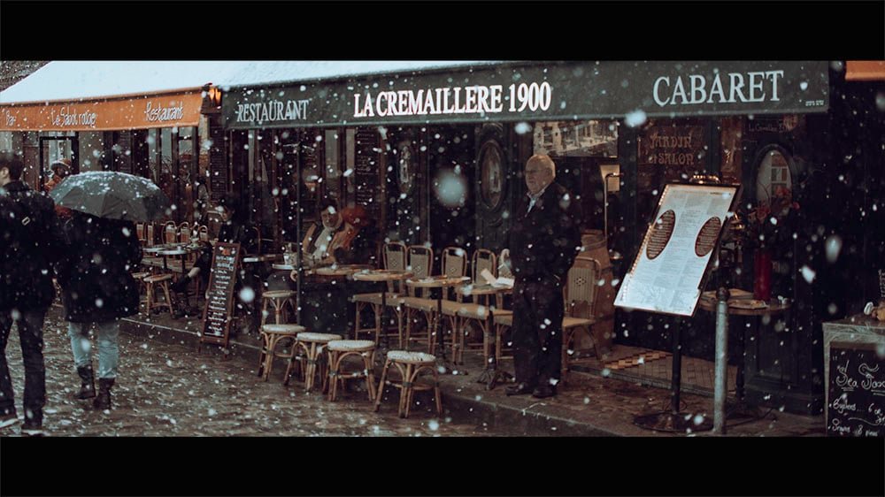snow falls in Montmartre, Paris creating a cinematic image.