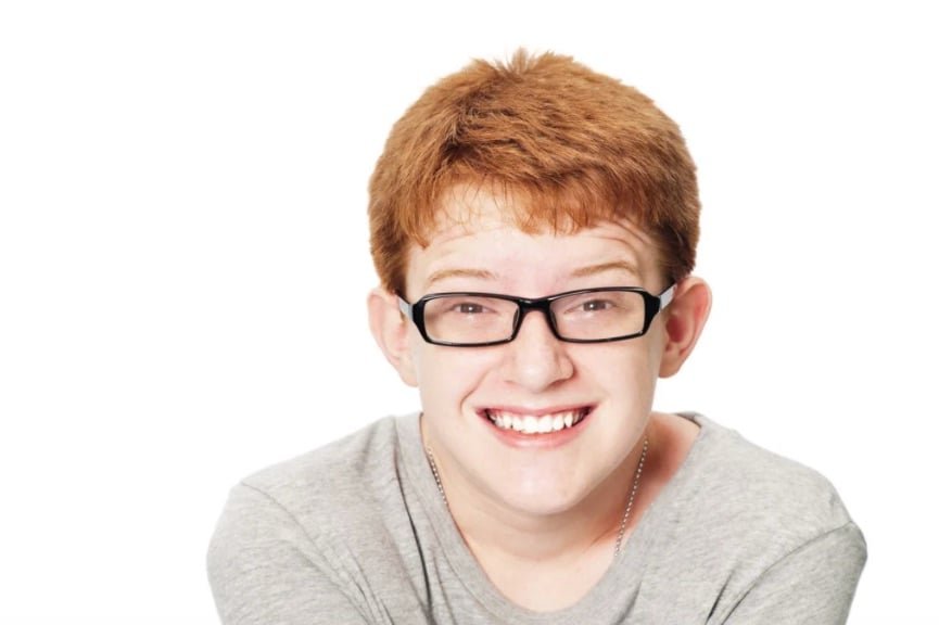 Happy teenage boy isolated on a white background in lightroom.