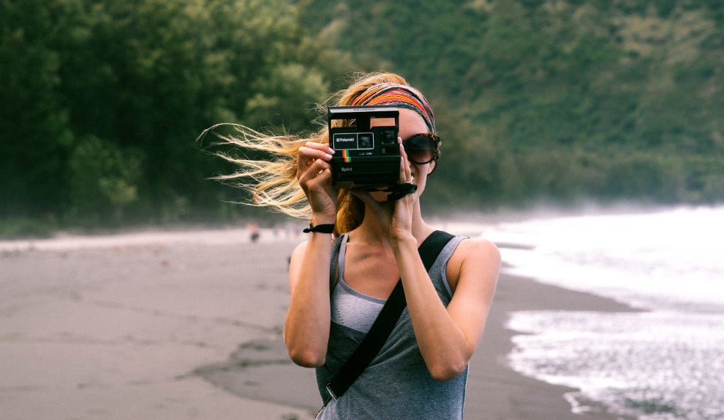 Woman using an instant camera.