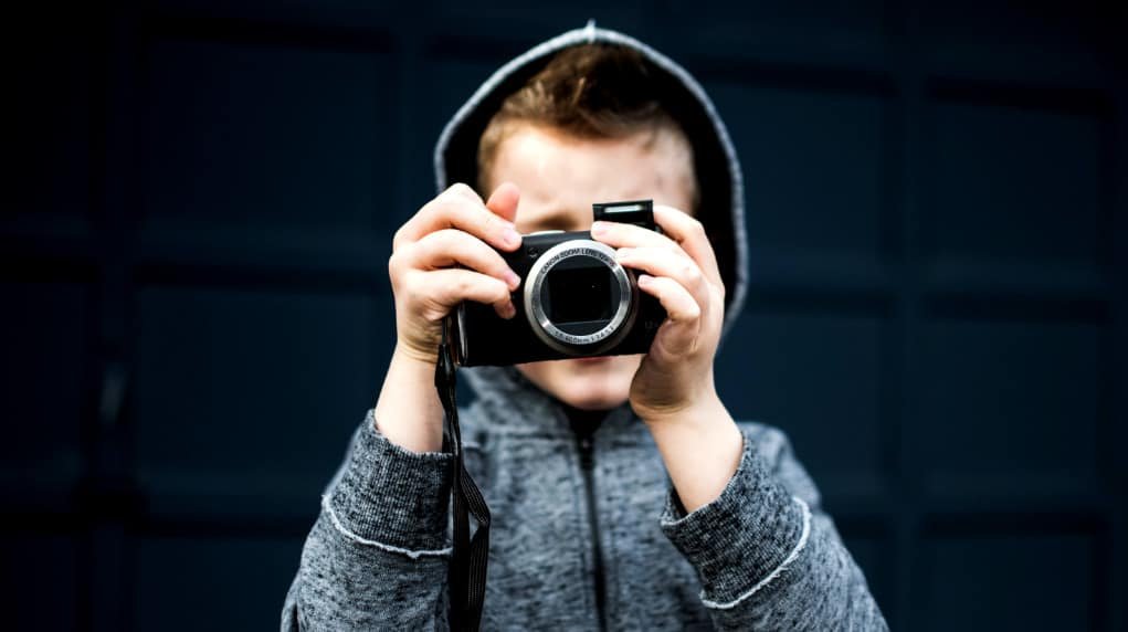 Child using a compact camera.