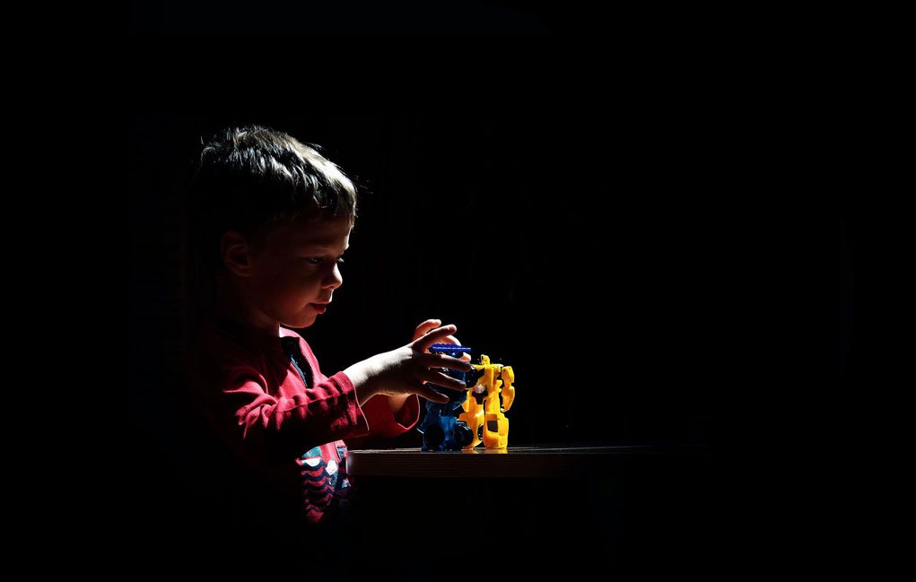 child paying, high contrast scene.