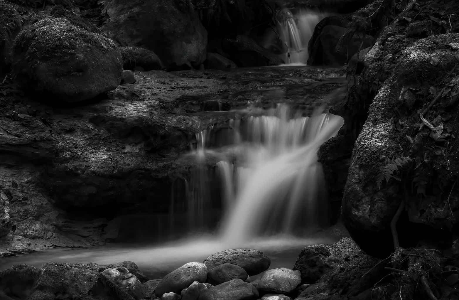 black and white long exposure shot of waterfall.
