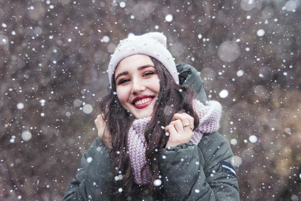 Portrait of woman with snow falling around.