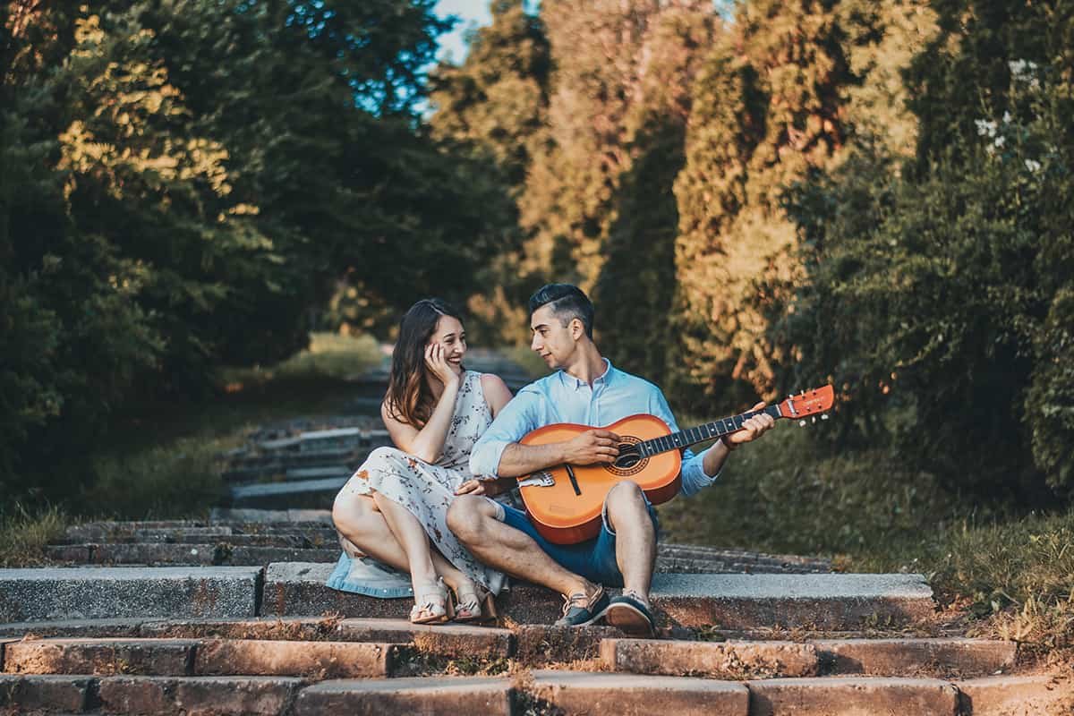couple poses man serenading girlfriend
