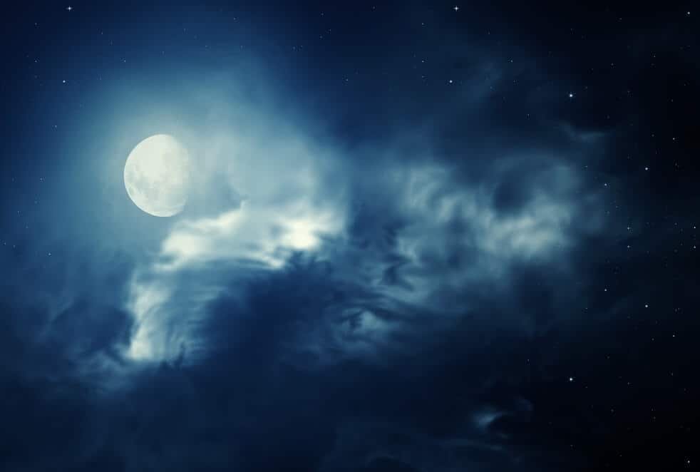 moon emerging from clouds.