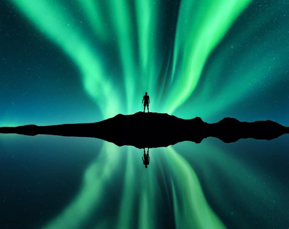 creative image of a silhouette against the Aurora Borealis.