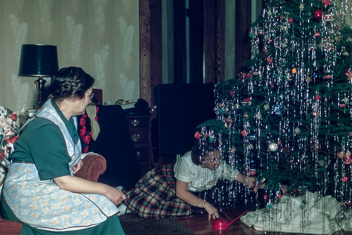 vintage family photo of two women decorating a Christmas tree.