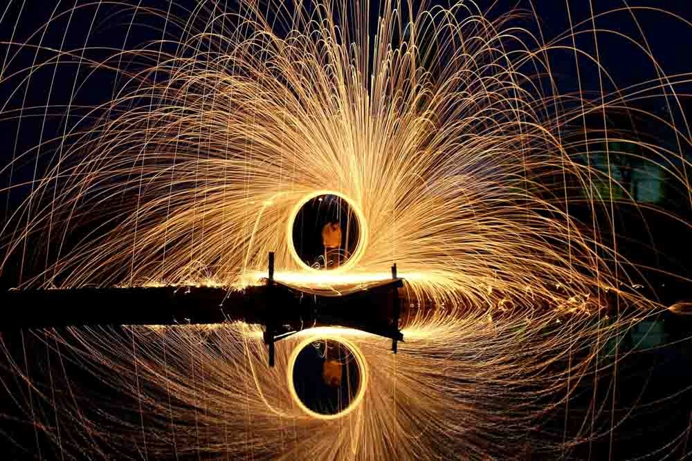 Light painting at night with steel wool fireworks.
