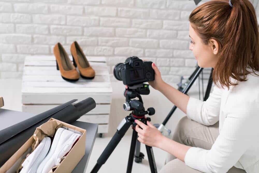 Product photographer shooting a pair of shoes.