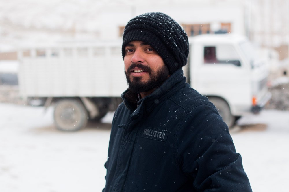 Man with cap and coat in the snow