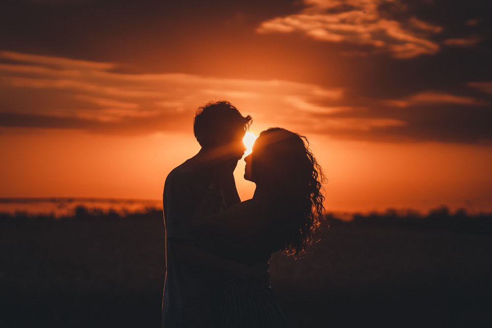 Silhouette of couple with sun behind them for romantic photos.