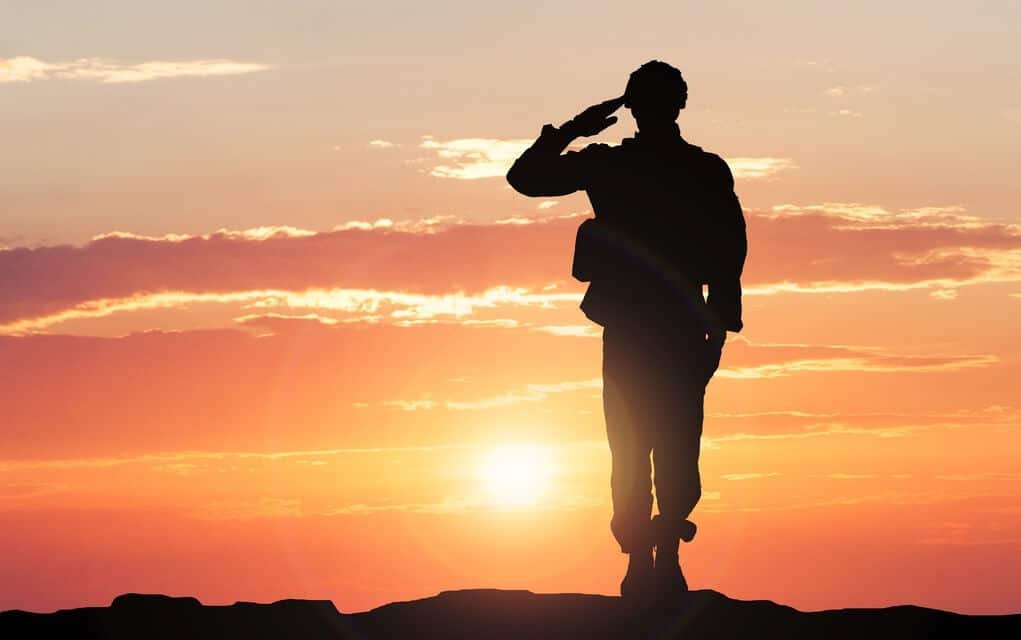 image of a soldier soldier saluting the setting sun